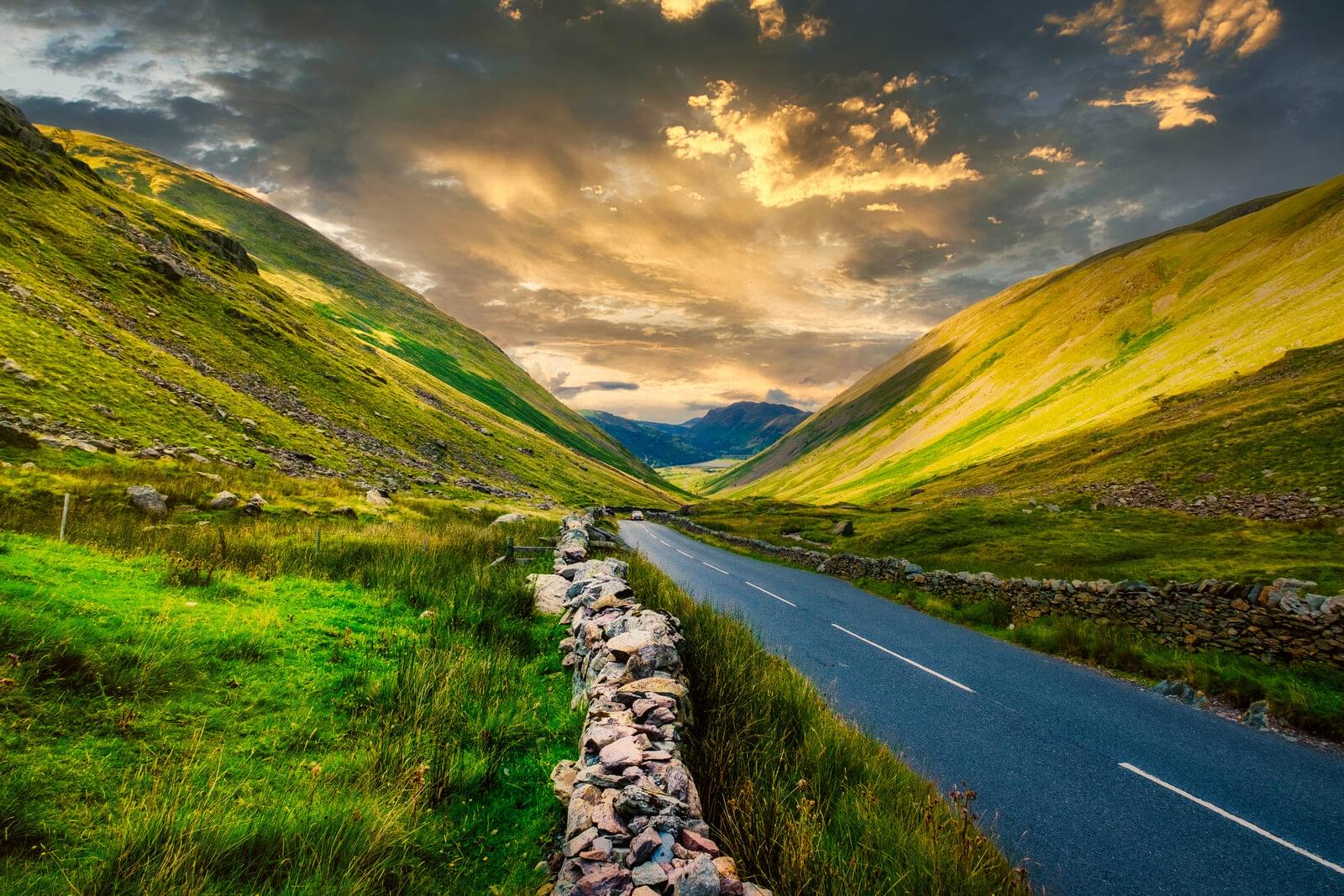 Sunset over a valley in the Lake District, the fells dark on either side and the last light along the floor